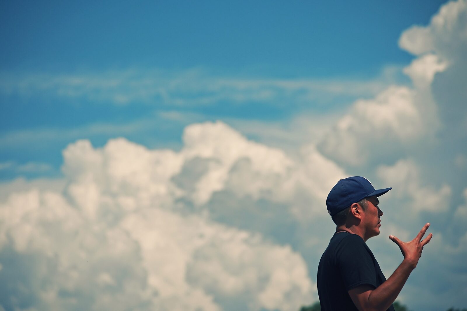 Billy Luther directing on set, hand raised mid-frame against a New Mexico sky.